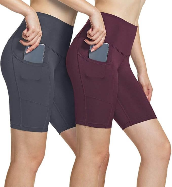 Women's high waisted yoga shorts in gray and burgundy with side pockets for convenience during workouts.