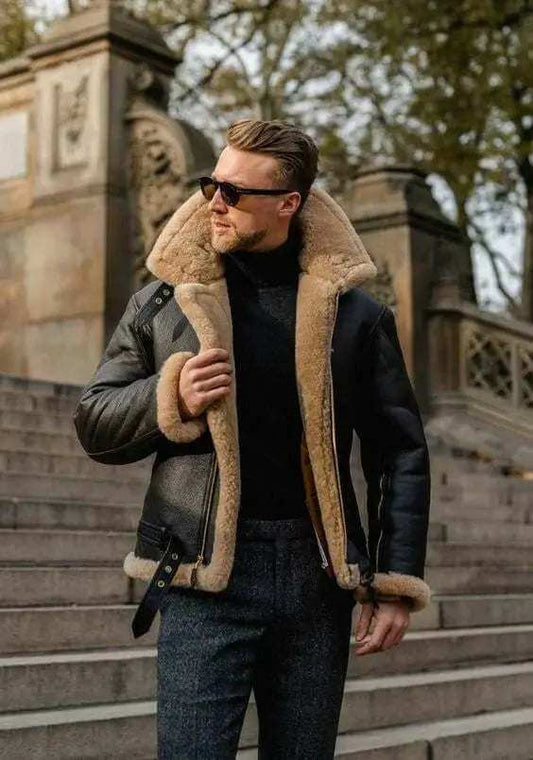 Man wearing a stylish black shearling leather jacket outdoors on stone steps in autumn setting