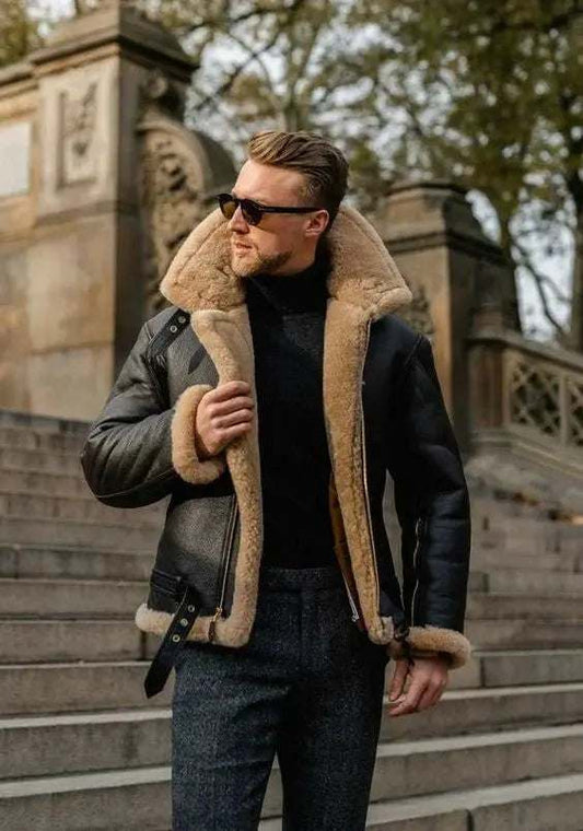 Man wearing a stylish black shearling leather jacket outdoors on stone steps in autumn setting