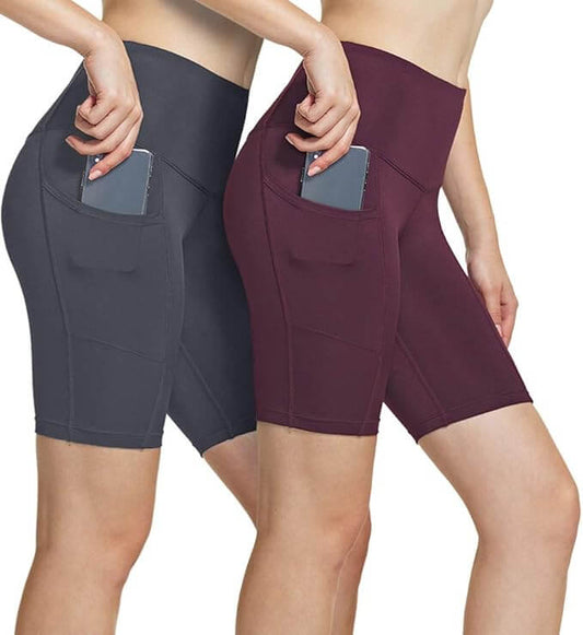 Women's high waisted yoga shorts in gray and burgundy with side pockets for convenience during workouts.