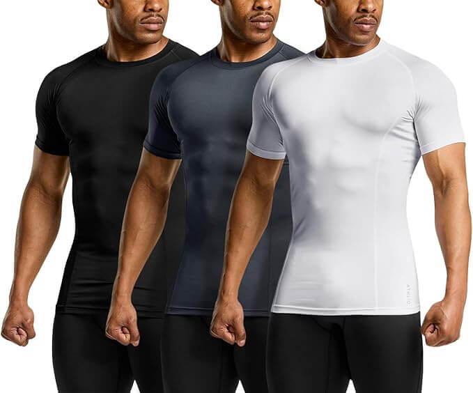 Men's compression shirts in black, navy, and white for sports and workouts, showcasing athletic fit and moisture-wicking fabric.