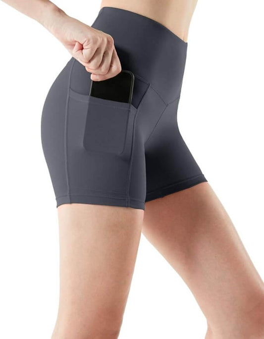 Women's high waisted yoga shorts in dark gray with side pocket holding a smartphone, perfect for exercise and storage.